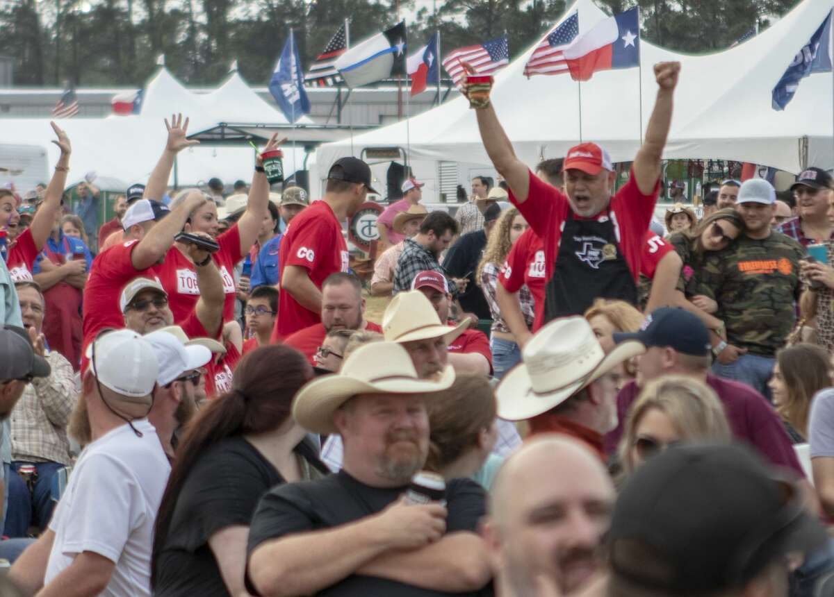 Members of Top Hand Cookers celebrate as they make their way through the crowd after being awarded 1st place for ribs during the awards ceremony for the Bud Light BBQ Cook-Off on Saturday, April 6, 2018, at the Montgomery County Fair & Rodeo in Conroe.