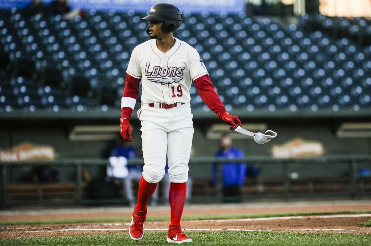 Great Lakes Loons left fielder Dan Robinson tosses a brace off the field after scoring a walk during a game against South Bend on Monday, April 8, 2019 at Dow Diamond. (Katy Kildee/kkildee@mdn.net)