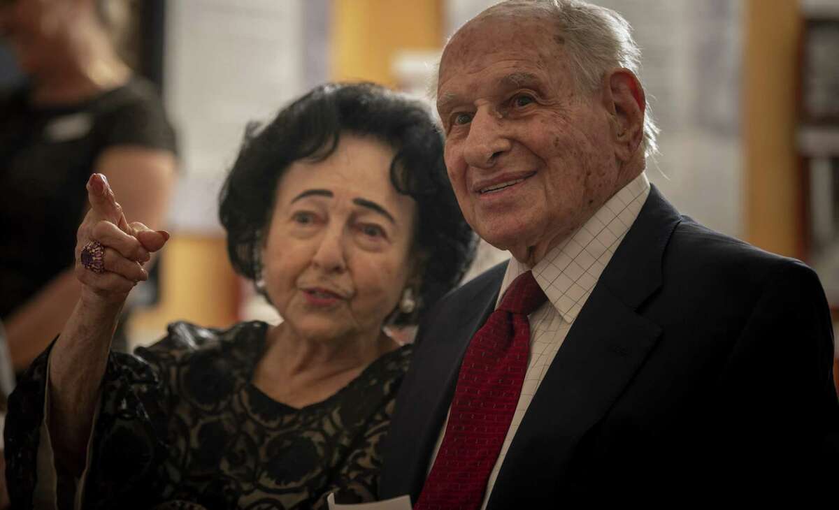 Gerd Miller and his wife, Dorothy, see someone they know before a ceremony begins Monday, organized by The Texas Holocaust and Genocide Commission to honor Miller, a World War II veteran from San Antonio, for helping to liberate the Dachau, Ebensee and Mauthausen concentration camps.