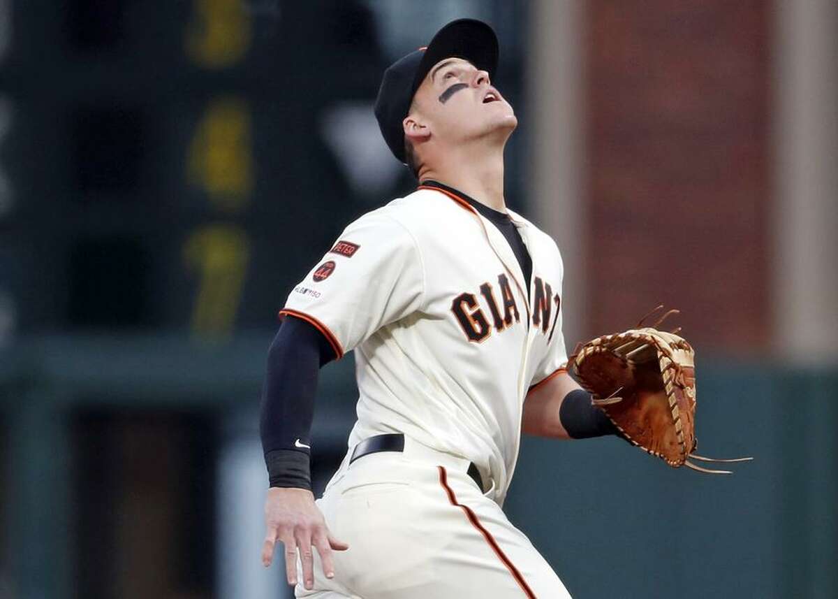 First baseman Tyler Austin tracks a popup hit by the Padres’ Wil Myers in the first inning of his first Giants game. Austin told reporters that he hadn’t seen Oracle Park before Monday.