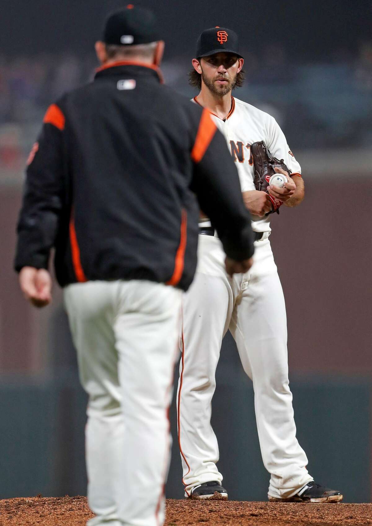 San Francisco Giants' Madison Bumgarner stares at manager Bruce Bochy during a 7th inning mound visit during MLB game against San Diego Padres at Oracle Park in San Francisco, Calif., on Monday, April 8, 2019.
