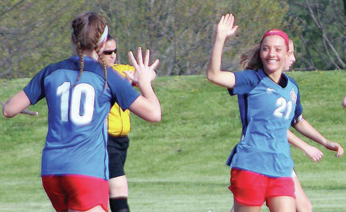 Carlinville’s Skylar Nickel (21) scored a pair of goals in Monday’s 6-0 win over East Alton-Wood River. She is shown celebrating a goal last season with teammate Lexi Egelhoff.