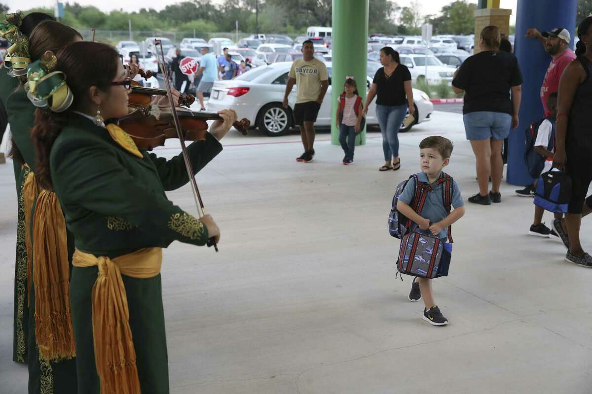 Three-year-old Bradley Miller checks out the Holmes High School Mariachi as he arrives for the first day of classes at the new Dr. Linda Mora Elementary School, Monday, August 27. The Northside Independent School District is well run — why three incumbents for board elections deserve reelection.