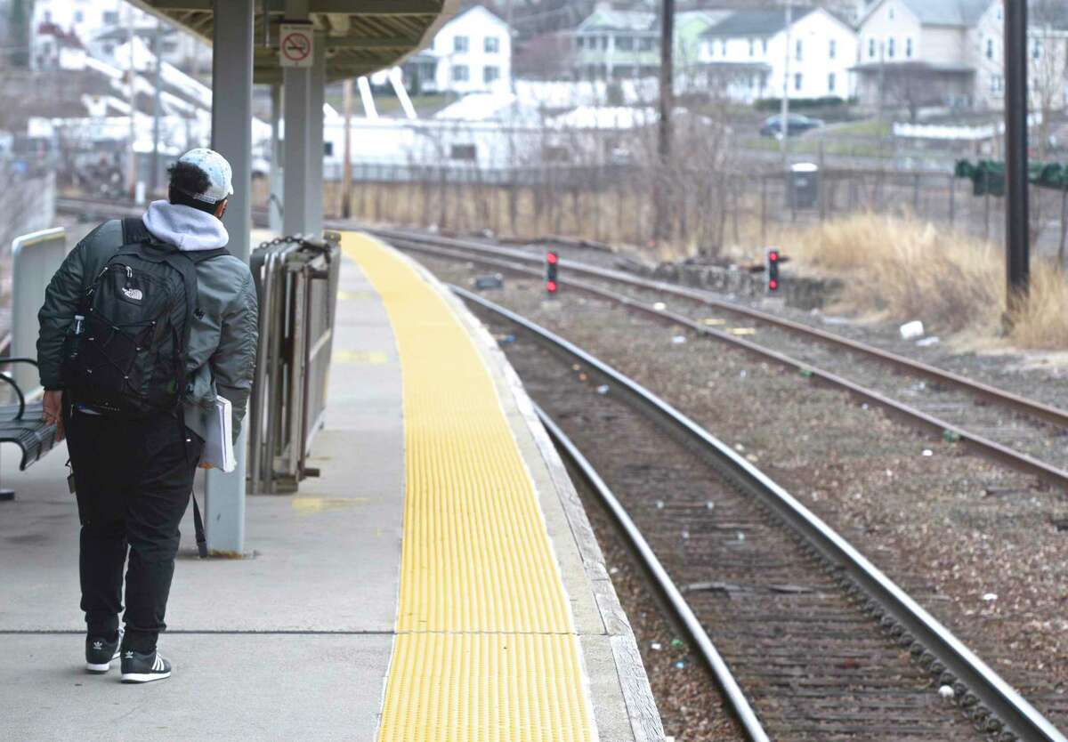 Justin Alam, a student at Western Connecticut State University, waits for a Metro North train at the Danbury train station. Tuesday, April 9, 2019, in Danbury, Conn.