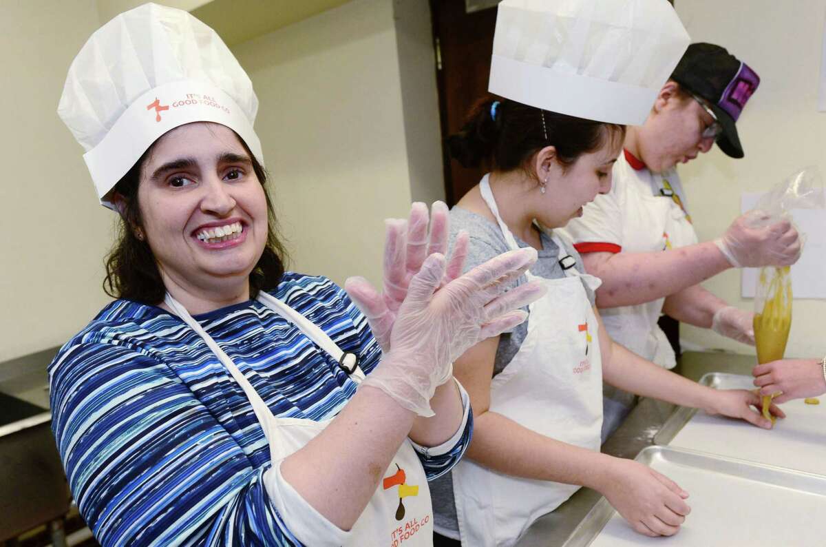 Gina Lopriore, Hillary Lipper, and Hannah Costa make crinkle cookies for Crumb Together Bakery Tuesday, Apriul 9, 2019, in the kitchen at Beth Israel Synagogue in Norwalk, Conn. Crumb Together Bakery was opened last October at Beth Israel Synagogue in Norwalk, as part of the work that the nonprofit Circle of Friends does to teach job skills to adults with disabilities.