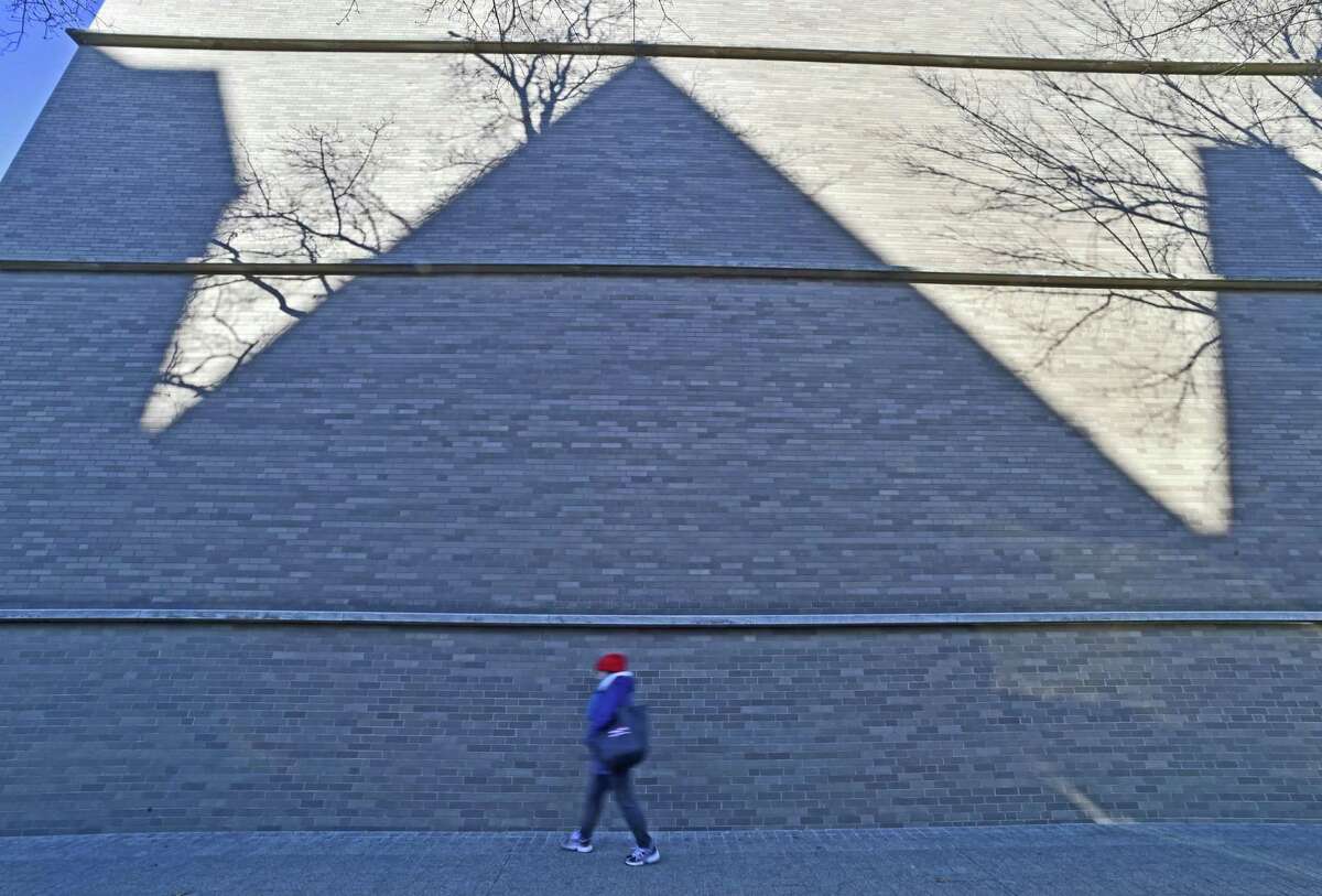 In this file photo, the chilly shadow of the Yale Repertory Theatre projected on the wall of the Yale University Art Gallery at the corner of York Street and Chapel Street in New Haven.