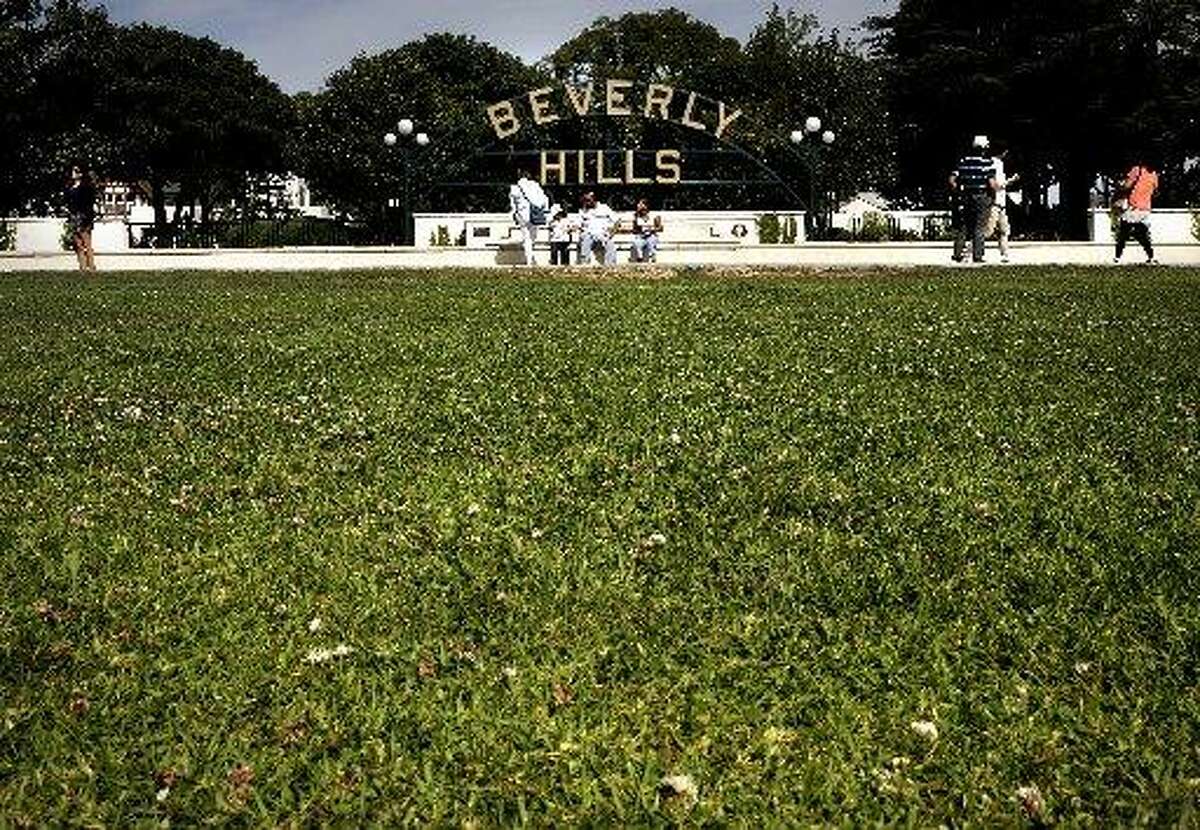 Green lawns at Beverly Gardens Park greet visitors to the Southern California City of Beverly Hills, Calif., as seen on Thurs. April 9, 2015.