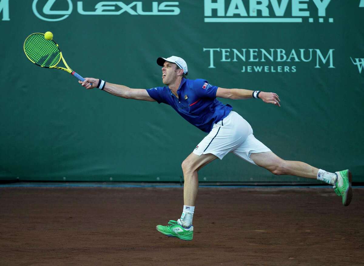 Sam Querrey reaches for a ball hit by Bjorn Fratangelo in a first round match of the Fayez Sarofim & Co. U.S. Men's Clay Court Championship at River Oaks Country Club in Houston, Tuesday, April 9, 2019.
