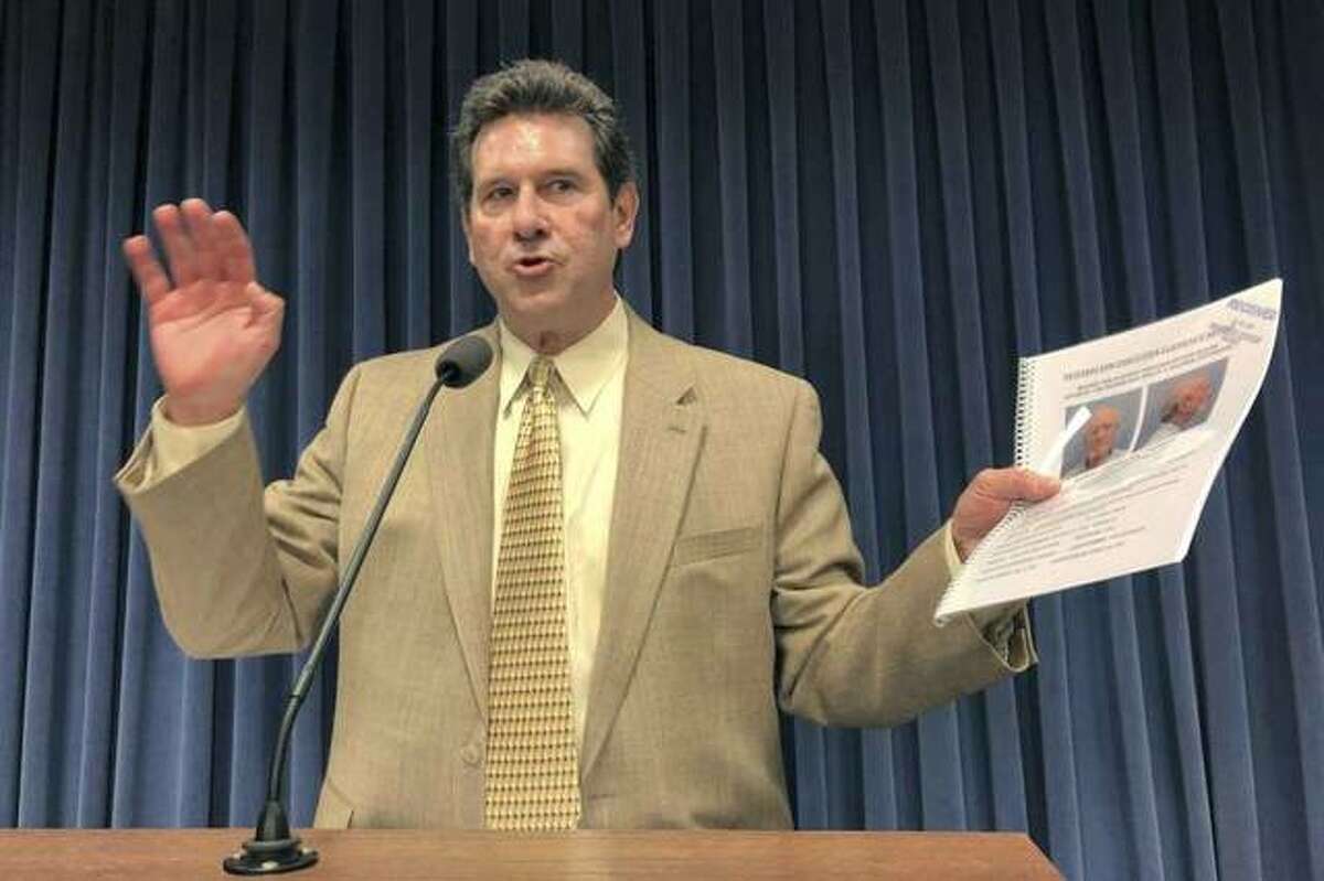 Bill Clutter, a private investigator who started the Illinois Innocence Project in 2001 and now runs a similar program from Louisville, Ky., discusses his proposal for the Illinois attorney general to create a “conviction integrity unit” to investigate claims of actual innocence by people convicted of crimes Tuesday, April 9, 2019, at the state Capitol, in Springfield, Ill. He is holding the clemency petition for the case he’s currently pursuing, the conviction of Thomas McMillen in the 1989 abduction and murder of Melissa Koontz of Springfield.