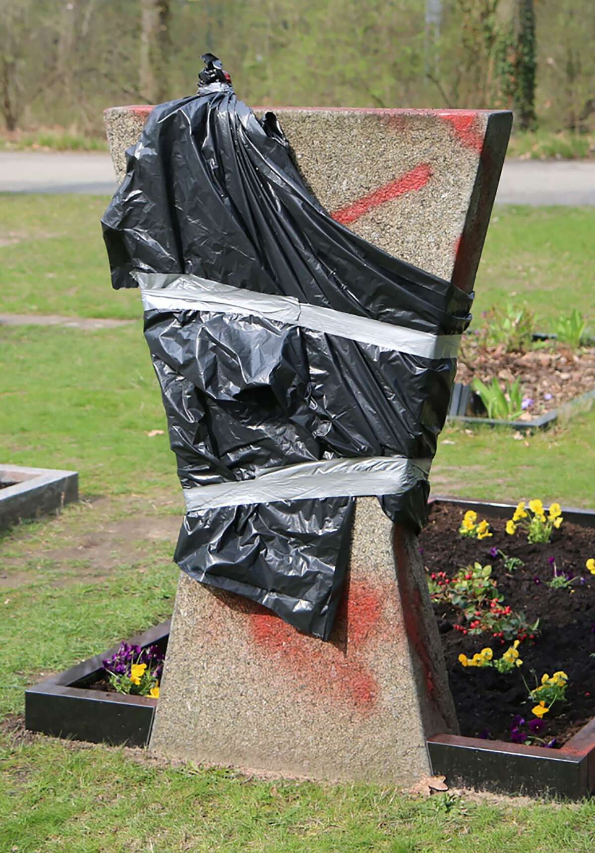 A gravestone covered with foil is pictured on the park cemetery Neukoelln in Berlin on April 3. Unidentified people smeared with swastikas the tombstones of two policemen killed in service on April 3 in Berlin, the police said.