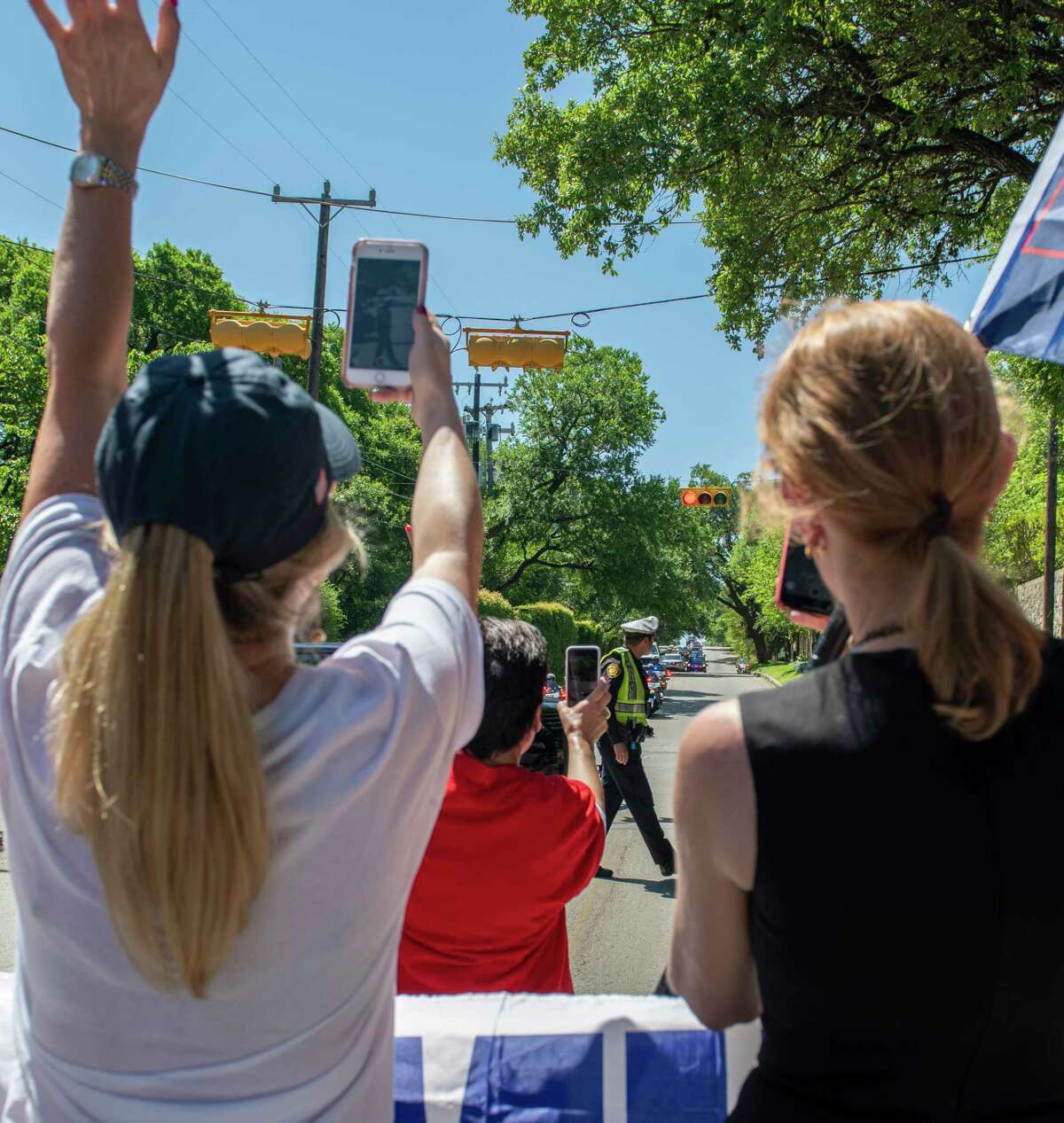 Trump supporters wave at President Donald Tump's motorcade on route to a fundraiser at Alamo Heights on Wednesday, April 10, 2019.