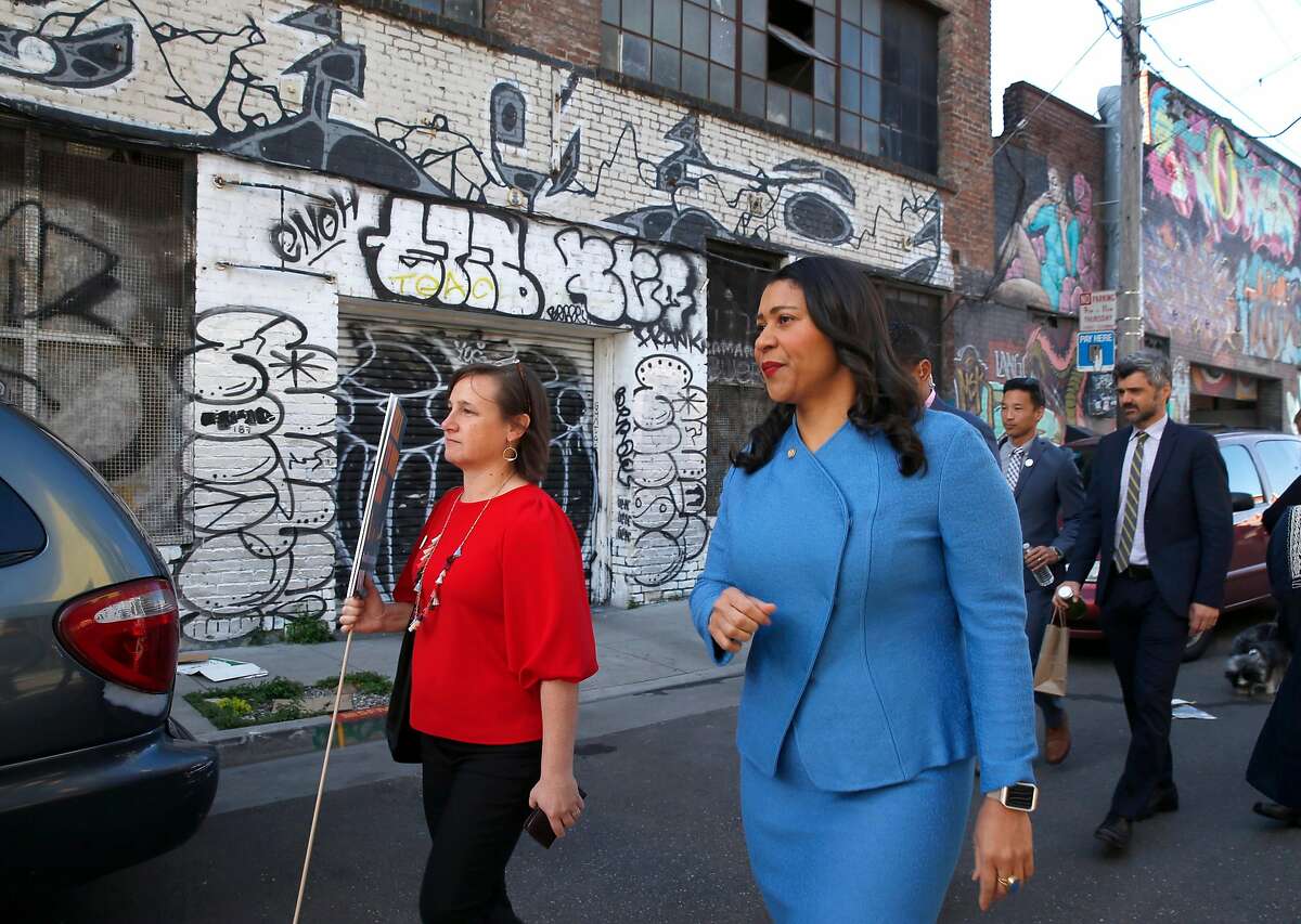 Walk San Francisco executive director Jodie Medeiros and Mayor London Breed lead a group on a stroll down Linden Street to City Hall for Walk to Work Day in San Francisco, Calif. on Wednesday, April 10, 2019.