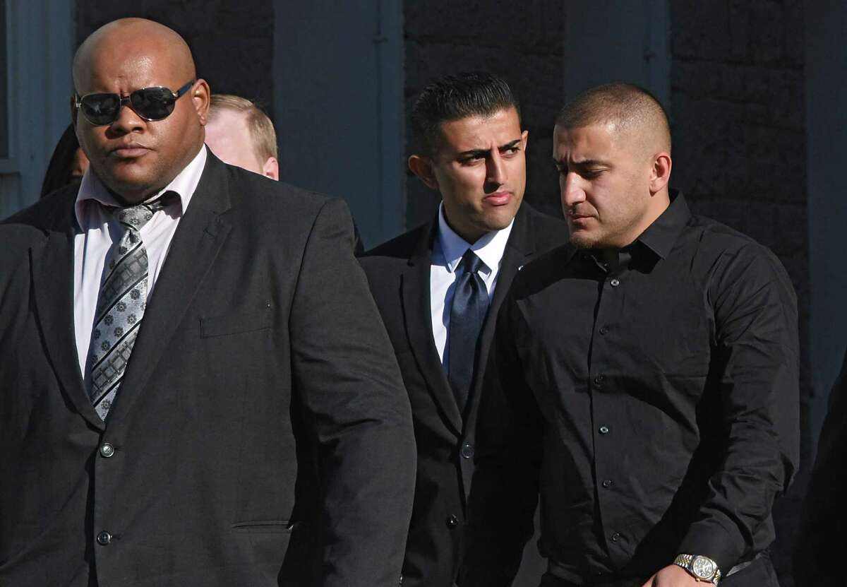 Nauman Hussain, the operator of Prestige Limousine, center, is surrounded by body guards as he leaves his arraignment at Schoharie County Court on Wednesday, April 10, 2019 in Schoharie, N.Y. Hussain had to post $450,000 bond and must wear a GPS. (Lori Van Buren/Times Union)