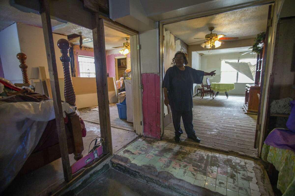 Annie Green stands in her Harvey-damaged home in northeast Houston, Tuesday, Jan. 15, 2019. Green has been working to find assistance completing repairs on the gutted house she lives in with her husband who suffers from Alzheimer's. She has had contractors begin work and disappear, even walking off with materials that were bought for her home.