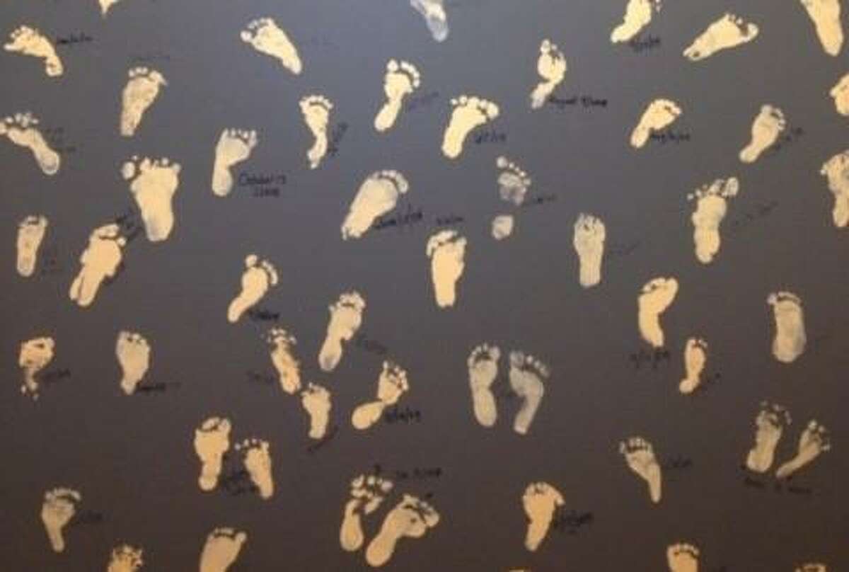 Footprints of babies born through assisted reproductive technology are displayed on a Wall of Honor at the Aspire Fertility Stone Oak office.
