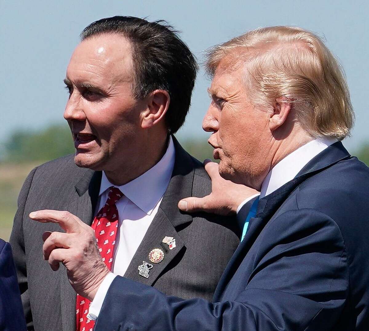 U.S. Rep. Pete Olson and President Donald Trump talk at Ellington Field, Wednesday, April 10, 2019 in Houston. Trump is scheduled to speak and sign executive orders on energy and infrastructure during his visit to the International Union of Operating Engineers (IUOE) International Training Center in Crosby.