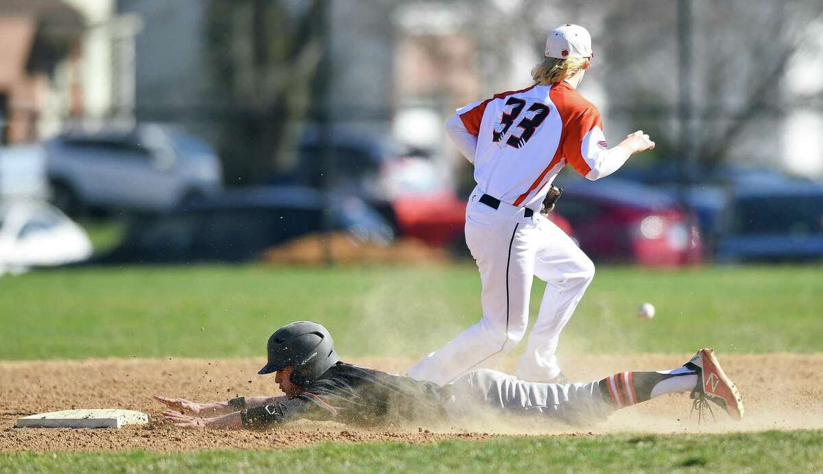 Stamford's David Callazo (3) makes a diving slide into second base ahead of the throw to Ridgefield's Colin LaCoille in an FCIAC baseball game on Wednesday, April 10, 2019 in Stamford, Connecticut. Ridgefield defeated Stamford 6-3.