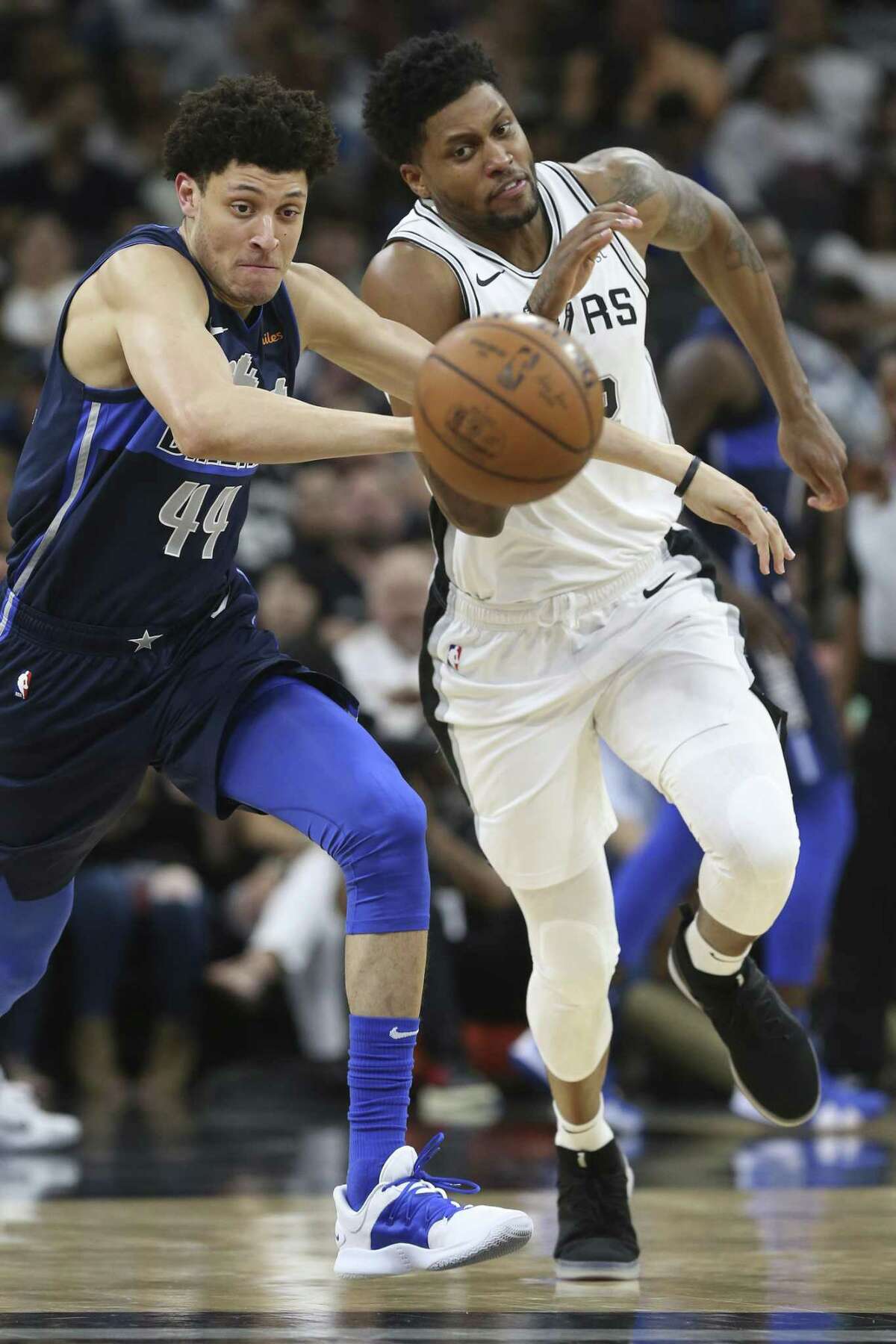 Dallas Mavericks’ Justin Jackson and San Antonio Spurs’ Rudy Gay chase a loose ball during the first half at the AT&T Center, Wednesday, April 10, 2019.