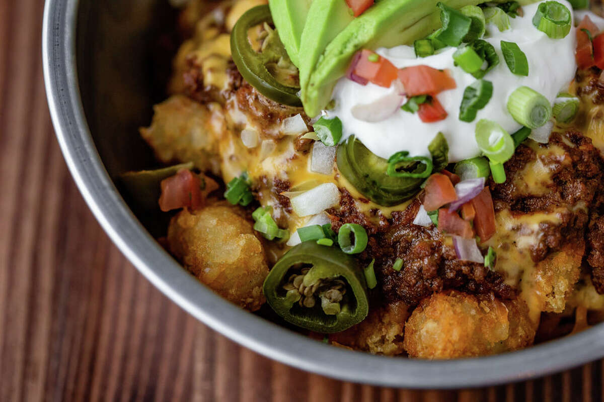 Loaded tots with chili, burnt ends, pulled pork and queso is among the new menu items at FM Kitchen & Bar, 1112 Shepherd.