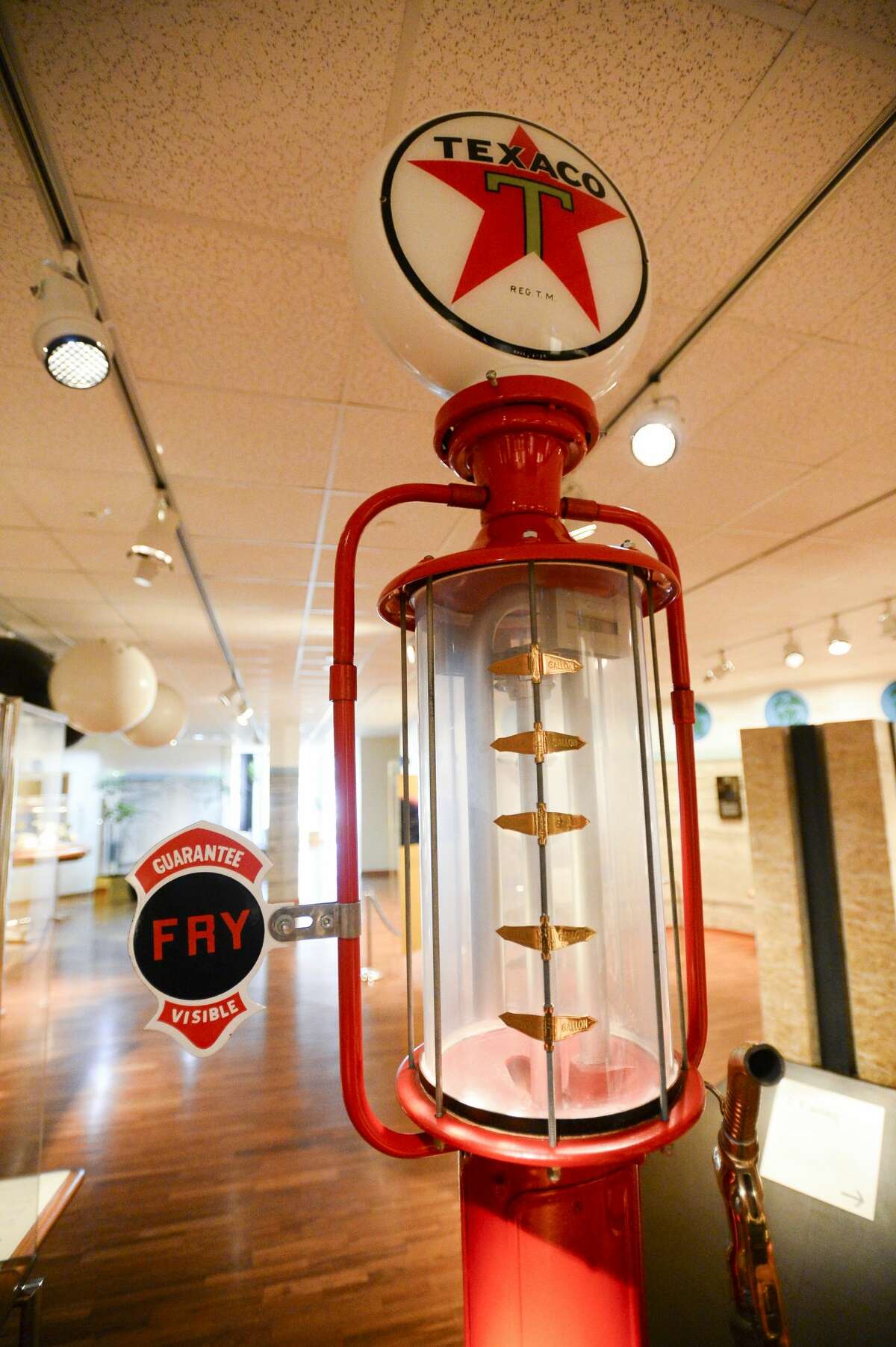 Shown here is a 1915 vintage gasoline pump on the first floor of the Texas Energy Museum. The clear container under the sign would hold the gas and allowed customers to see the gas before it was put into their car. Photo taken on Tuesday, 03/05/19. Ryan Welch/The Enterprise