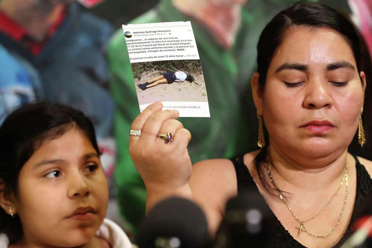 Doris Avardo (right) shows a photo of a friend of her family that was killed in El Salvador as her Laura Maradiaga,11, is facing deportation back Thursday, April 11, 2019, in Houston.