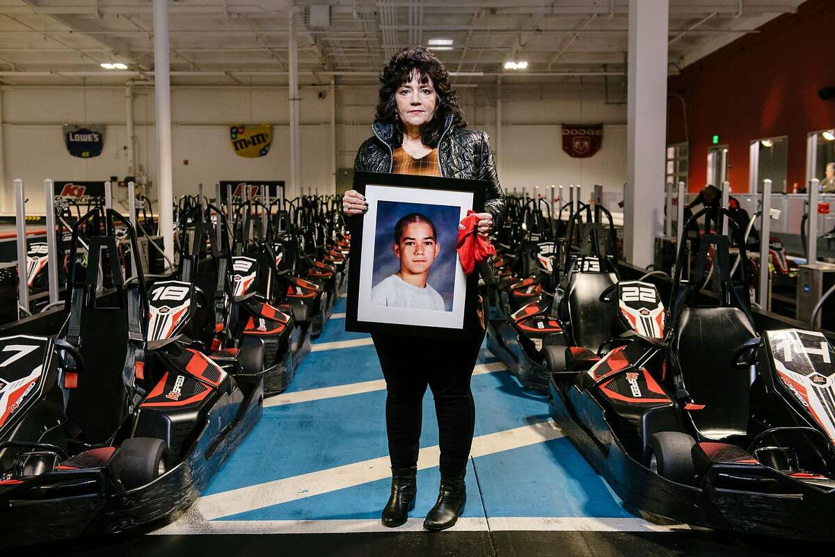 Tonya Batorski holds a picture of her son Max as she poses for a portrait at K1 Speed go-kart racing track where, as a yearly tradition, she would take her son, who passed away in 2017, to celebrate his birthday, in Dublin, Calif., on Friday March 29, 2019. Tonya Batorski's late son Max was one of the boys who's testimony against Dr. Patrick Clyne, a Bay Area pediatrician and former foster parent accused of sexual abuse by more than a dozen children and teens since 2001, was presented to a criminal grand jury but did not lead to an indictment.
