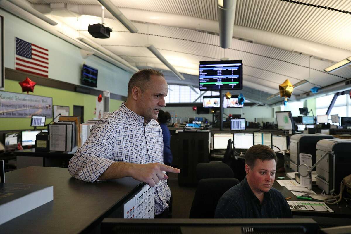 Josu Garmendia (l to r), dispatch center day shift coordinator, works with Max Repka (right), lead dispatcher as Garamendia trains Repka to be a supervisor in the dispatch center at the San Francisco Department of Emergency Management on Wednesday, April 10, 2019 in San Francisco, Calif.