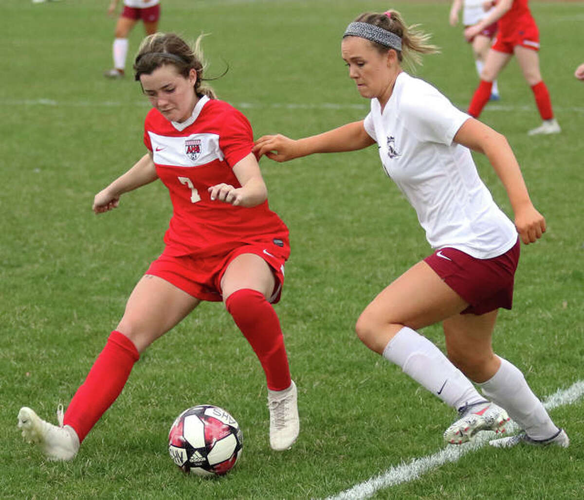 Alton’s Grace Nasello (left) possesses the ball against pressure from Belleville West’s Katelyn Grandcolas during the second half Thursday at Piasa Motor Fuels Field in Godfrey.