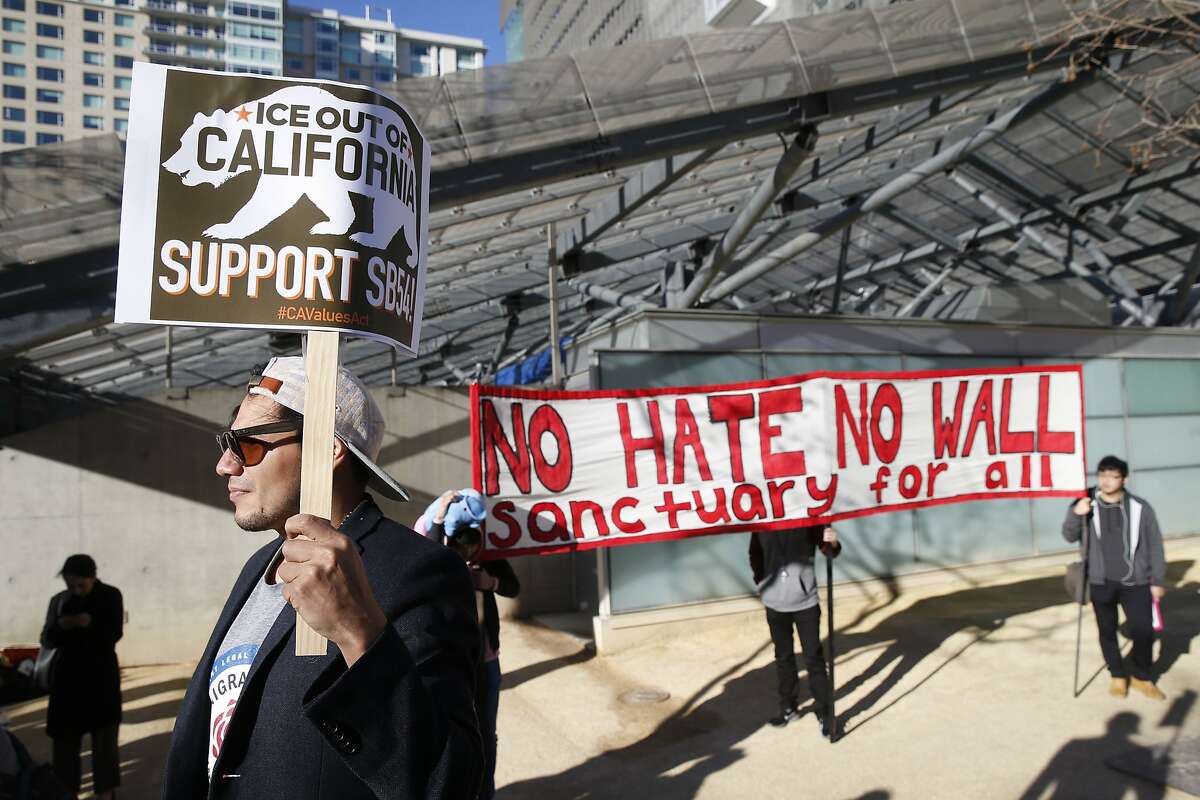 Krsna Avila attends a rally across the street from the James R. Browning United States Courthouse where the 9th Circuit Court of Appeals hears arguments in President Trump's lawsuit against California's sanctuary law that protects immigrants in San Francisco, Calif. on Wednesday, March 13, 2019.