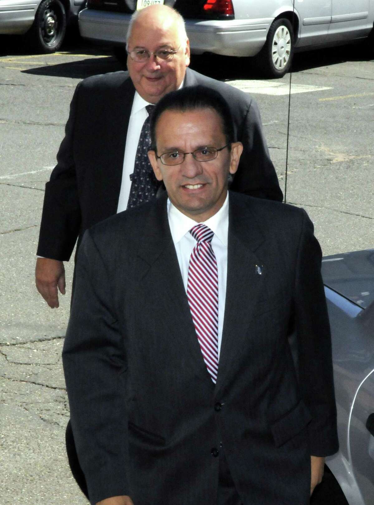 Hartford Mayor Eddie A. Perez, followed by his attorney, Hubert J. Santos, arrive at state police barracks Troop H in Hartford, Conn., on Wednesday, Sept. 2, 2009.