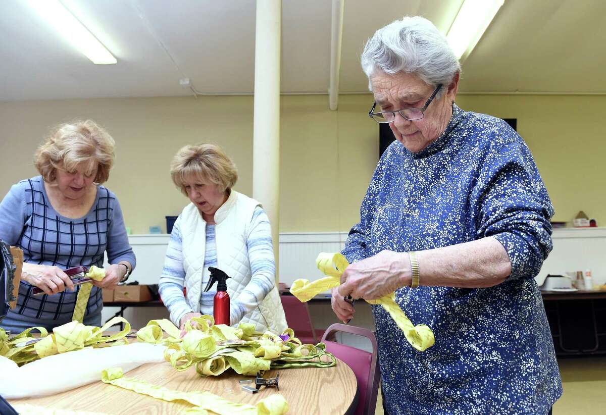 In New Haven, from left, Therese Incarnato of New Haven, Mary Florenzano of New Haven and Mary Quinlan of East Haven assemble palm crosses for Palm Sunday in the basement of St. Michael Church April 11, 2019. This is the third year that volunteers under the direction of Jean Quartiano have made palm crosses for parishioners of the church.