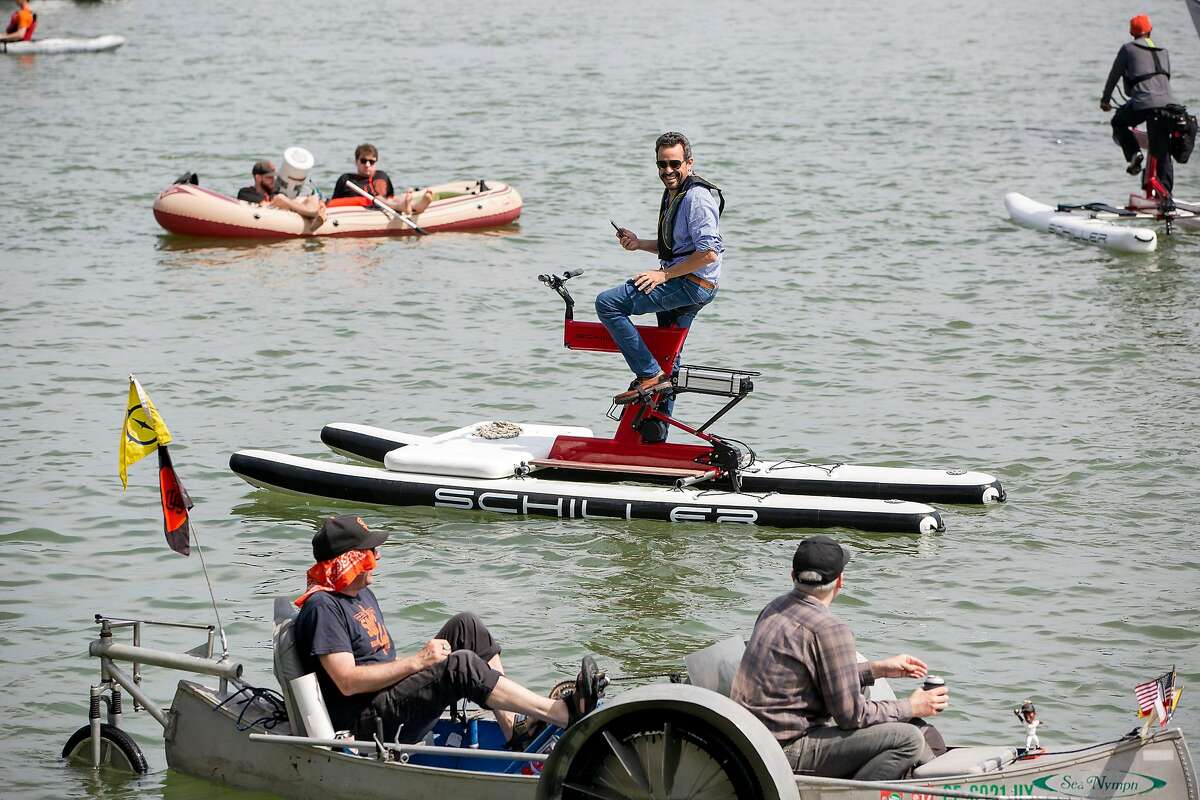 Richard Pulliam talks with fellow boaters while he demonstrates the electric-assisted water bikes at McCovey Cove in San Francisco, Calif. on Sunday, April 7, 2019.