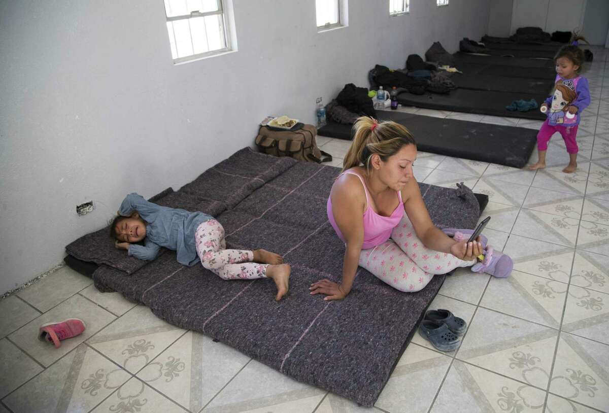 Katherin Molina, 22, cries while speaking to her family on the phone at a shelter on Monday, April 8, 2019, in Ciudad Juárez. After the Honduran family of four waited to request asylum at the El Paso port of entry, as is permitted under current U.S. law, they were returned last week to Juárez under a short-lived Trump administration policy making asylum seekers wait in Mexico. They are now taking shelter at a vacant fire station building on the outskirts of Ciudad Juárez and are part of more than 3,500 migrants waiting in that city to cross into the United States.