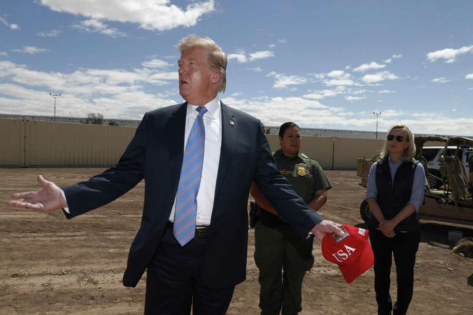 President Donald Trump visits a new section of the border wall with Mexico in Calexico, Calif., on Friday April 5, 2019. Gloria Chavez with the U.S. Border Patrol, center, and then-Homeland Security Secretary Kirstjen Nielsen listen. Nielsen’s resignation was announced days later. Photo: Jacquelyn Martin, STF / Associated Press / Copyright 2019 The Associated Press. All rights reserved.