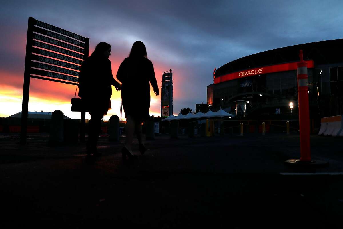 Two Golden State Warriors' fans arrive late for game against Phoenix Suns at Oracle Arena in Oakland, Calif., on Sunday, March 10, 2019.
