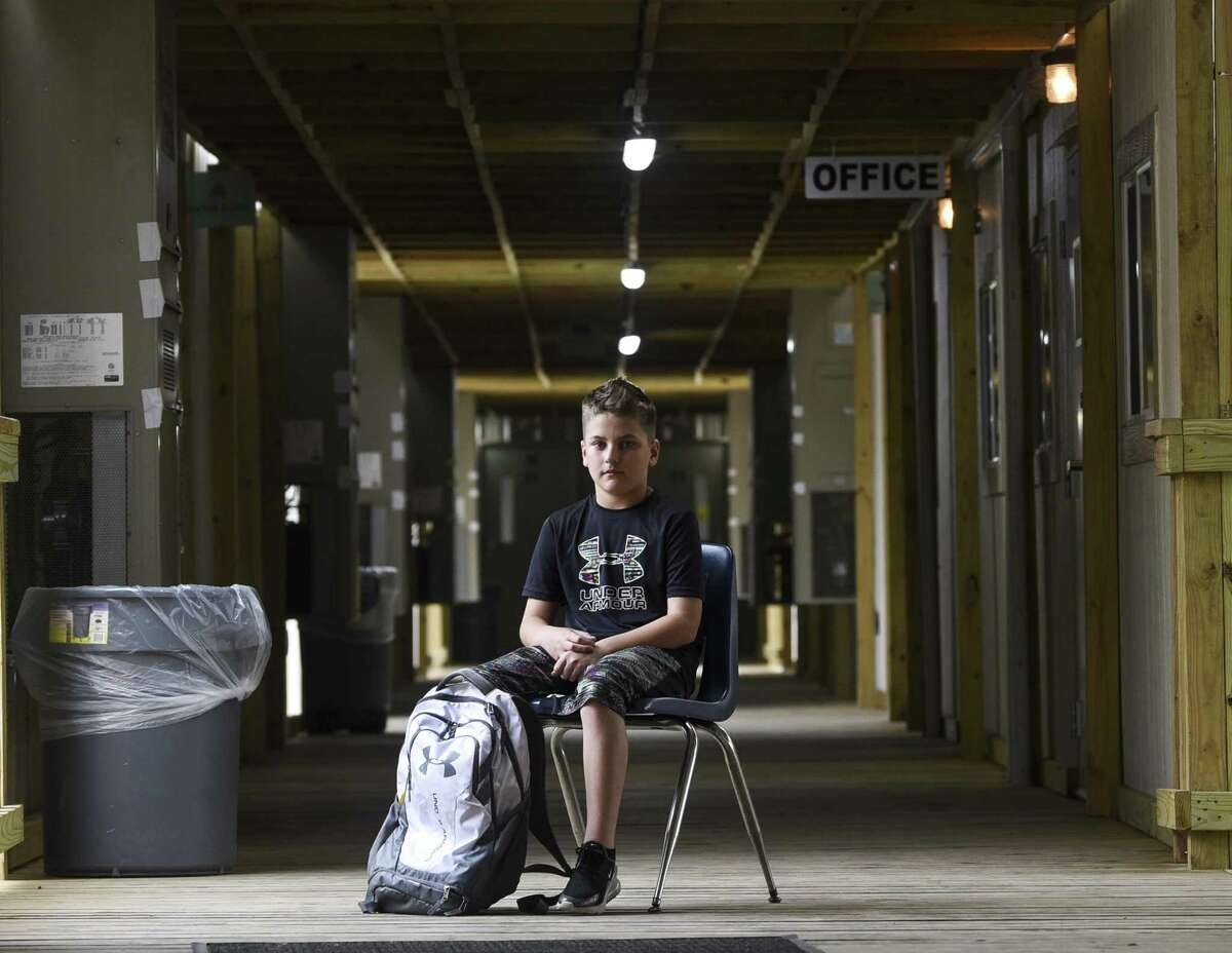 Hayden Seigrist, a 12-year-old sixth-grader, poses for a photo at Vidor Middle school's sixth-grade portable campus on the Vidor Middle school campus. He as been a student through both the re-purposed high school class rooms and the portable buildings due to damage from Harvey. Photo taken on Friday, 04/05/19. Ryan Welch/The Enterprise