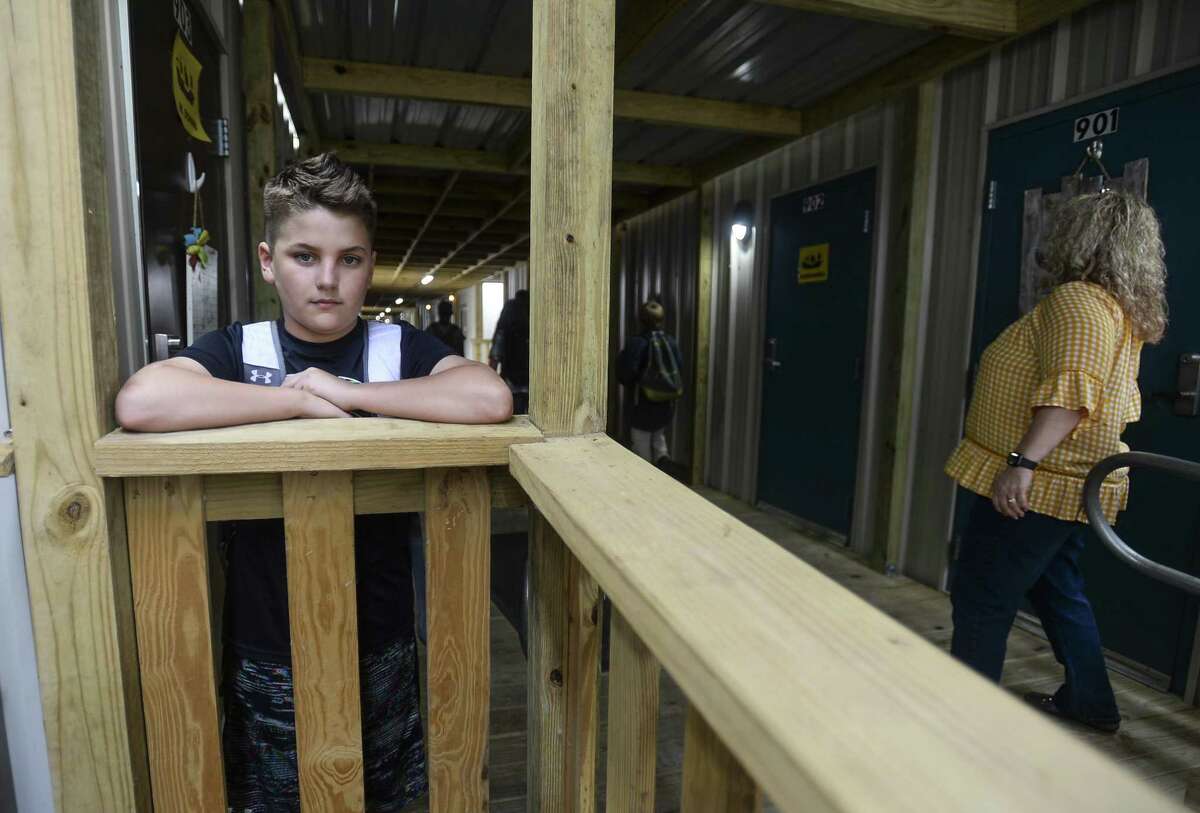 Hayden Seigrist, a 12-year-old sixth-grader, poses for a photo at Vidor Middle school's sixth-grade portable campus on the Vidor Middle school campus. He as been a student through both the re-purposed high school class rooms and the portable buildings due to damage from Harvey. Photo taken on Friday, 04/05/19. Ryan Welch/The Enterprise