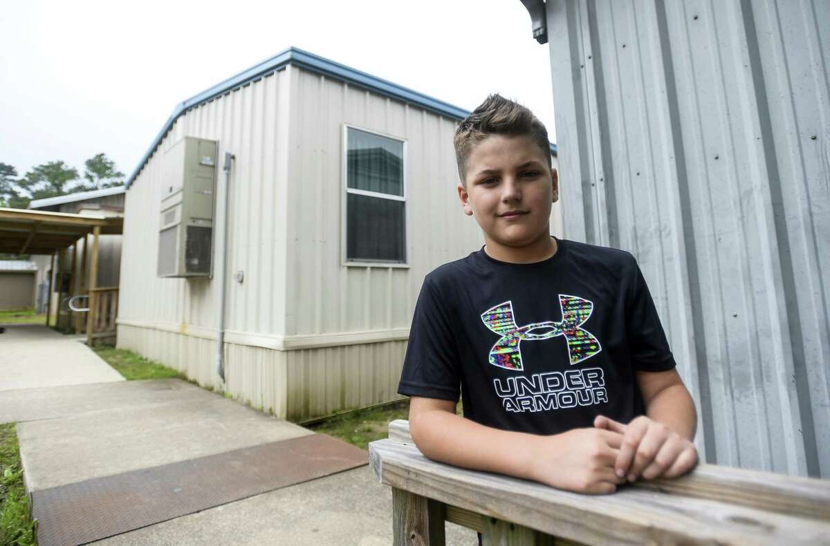 Hayden Seigrist, a 12-year-old sixth-grader, poses for a photo at Vidor Middle school's sixth-grade portable campus on the Vidor Middle school campus. He as been a student through both the re-purposed high school class rooms and the portable buildings due to damage from Harvey. Photo taken on Friday, 04/05/19. Ryan Welch/The Enterprise