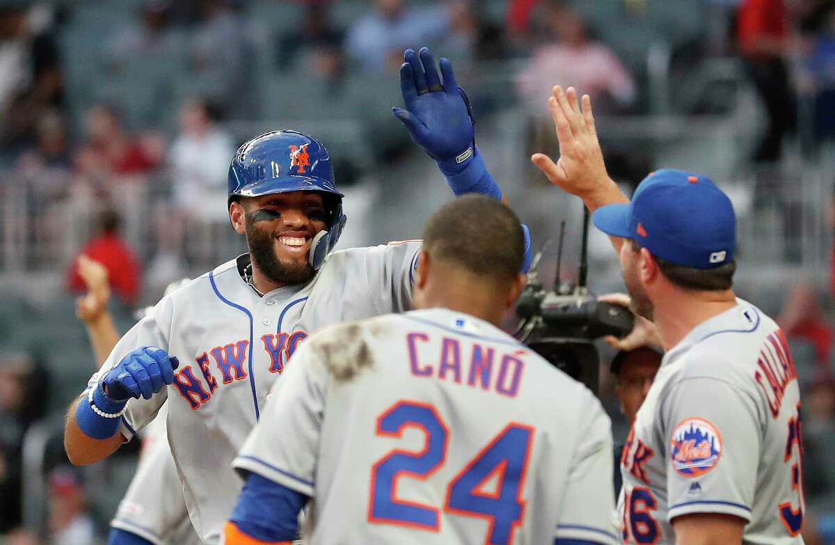 New York Mets' Amed Rosario (1) is welcomed to the dugout by manager Mickey Callaway (36) and Robinson Cano (24) after hitting a three-run home run during the second inning of the team's baseball game against the Atlanta Braves on Thursday, April 11, 2019, in Atlanta. (AP Photo/John Bazemore)