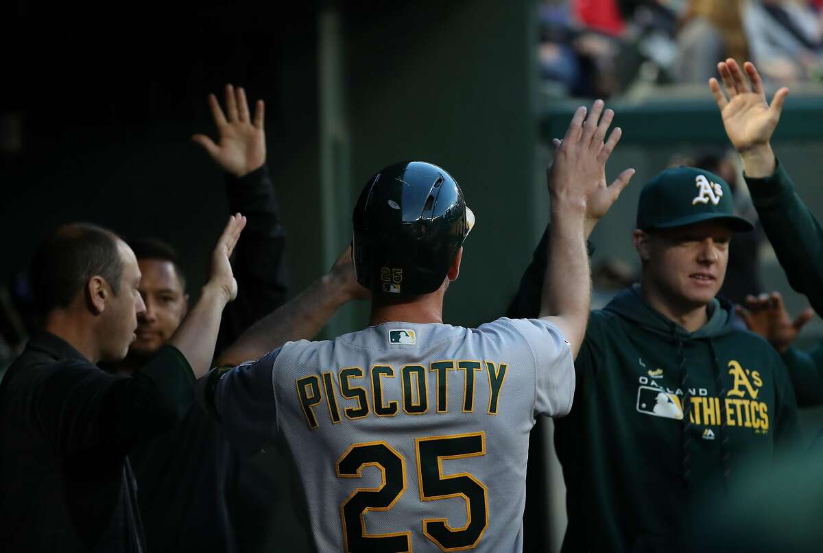 ARLINGTON, TEXAS - APRIL 12: Stephen Piscotty #25 of the Oakland Athletics celebrates a run against the Texas Rangers in the second inning at Globe Life Park in Arlington on April 12, 2019 in Arlington, Texas. (Photo by Ronald Martinez/Getty Images)