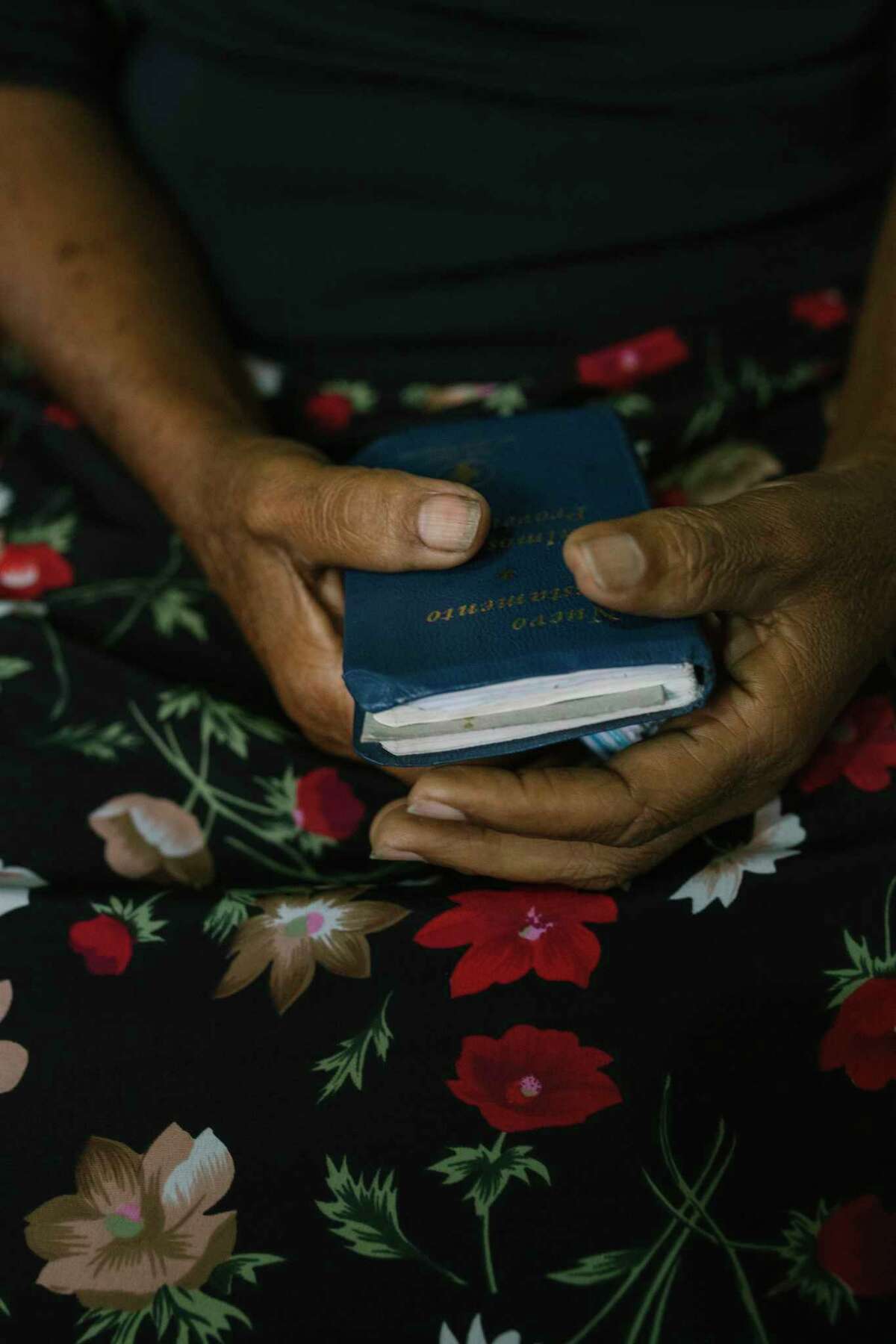 Mary Mendoza holds the New Testament as she waits for a service at an evangelical Christian church in the Caracas slum of Petare.
