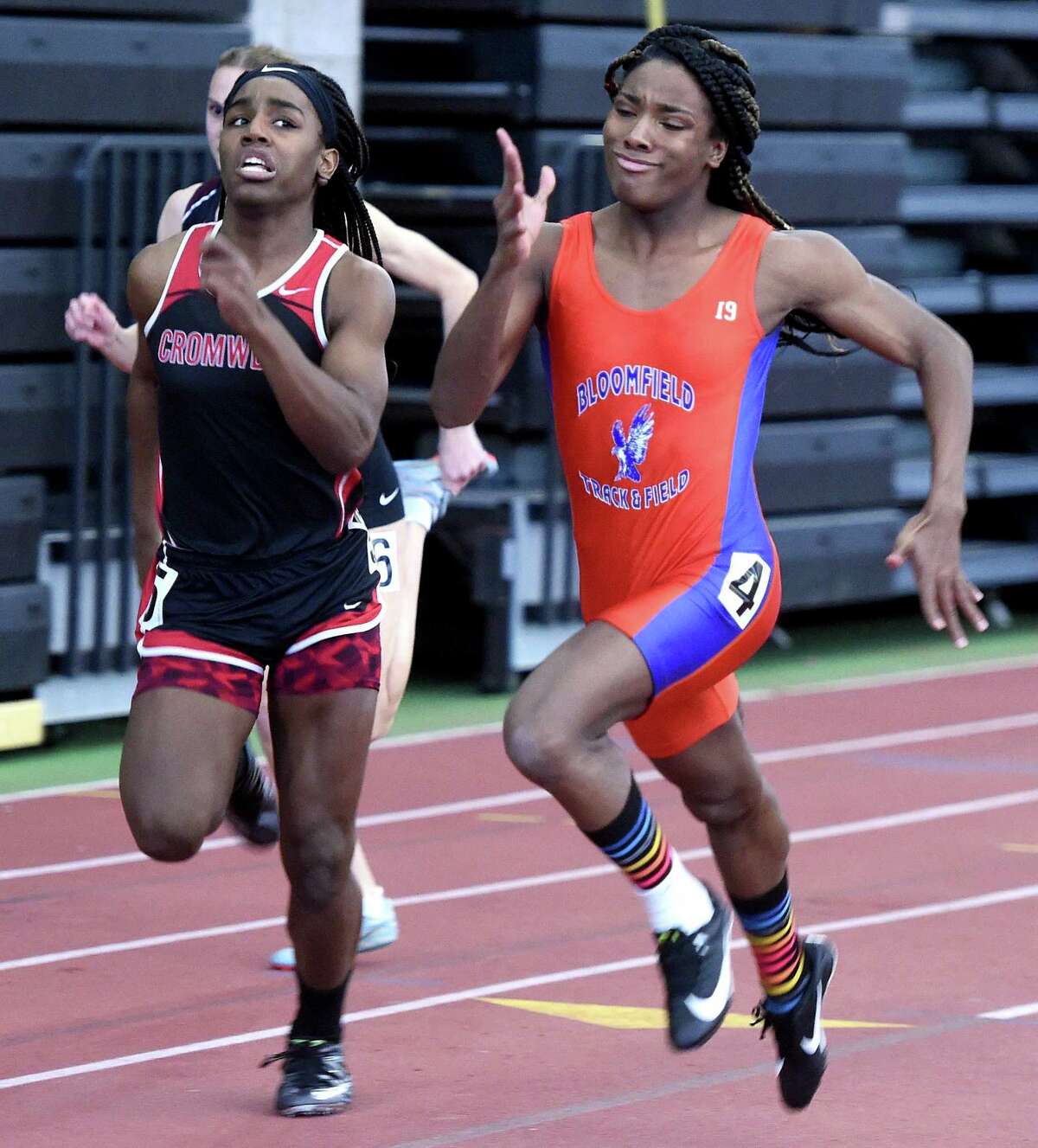 Bloomfield’s Terry Miller, right, runs to a first-place finish in the 55-meter dash at the State Open track championship at the Floyd Little Athletic Center in New Haven on Feb. 16.