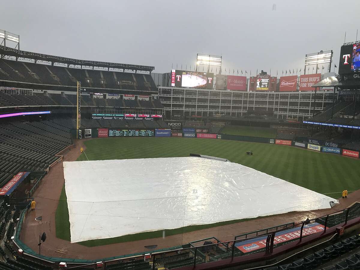 The Rangers placed the tarp on the field more a hour before their game against the A's.