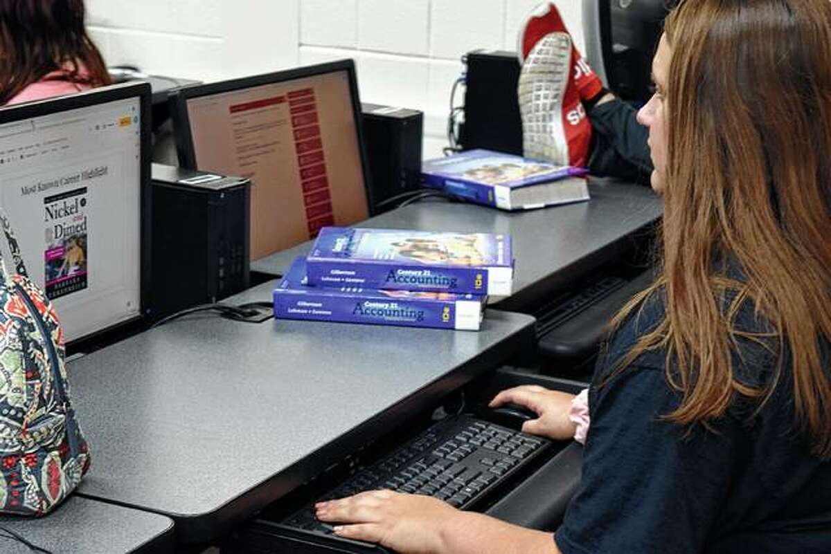 Jacksonville High School senior Camri Anderson looks up articles during her journalism class Thursday.