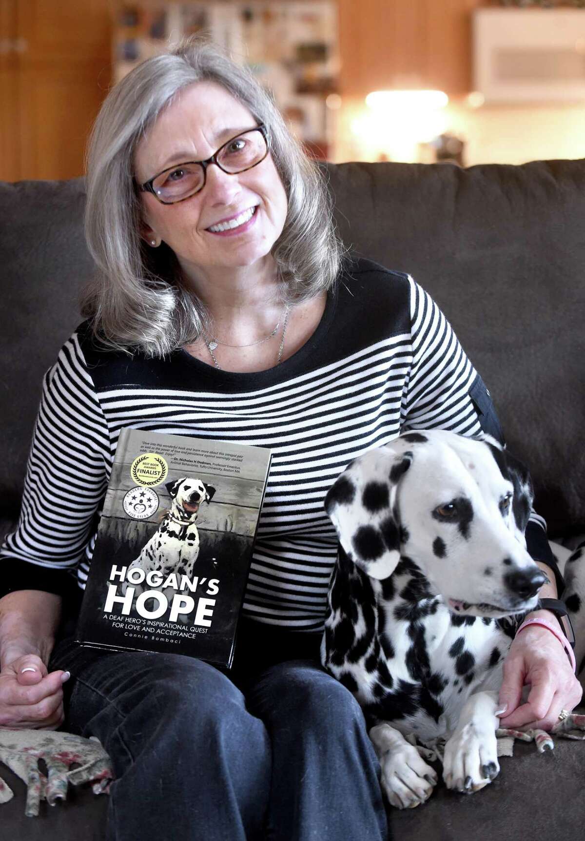 Connie Bombaci is photographed with her deaf Dalmatian, Judea, at her home in Killingworth last April. Her book, “Hogan’s Hope,” is a story about her first deaf Dalmatian.