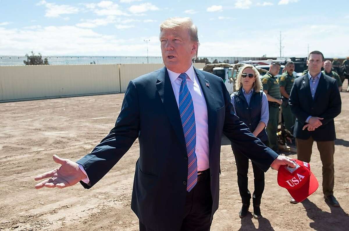 (FILES) In this file photo taken on April 5, 2019 US President Donald Trump speaks with members of the US Customs and Border Patrol as he tours the border wall between the United States and Mexico in Calexico, California. - The White House confirmed April 14, 2019 it is looking at ways to transfer undocumented migrants to US sanctuary cities as Democrats accused President Donald Trump of creating "manufactured chaos" at the US-Mexico border."This is an option on the table," White House press secretary Sarah Sanders said in an interview on ABC's "This Week."Trump "heard the idea, he likes it, so - well, we're looking to see if there are options that make it possible and doing a full and thorough and extensive review," she said. (Photo by SAUL LOEB / AFP)SAUL LOEB/AFP/Getty Images