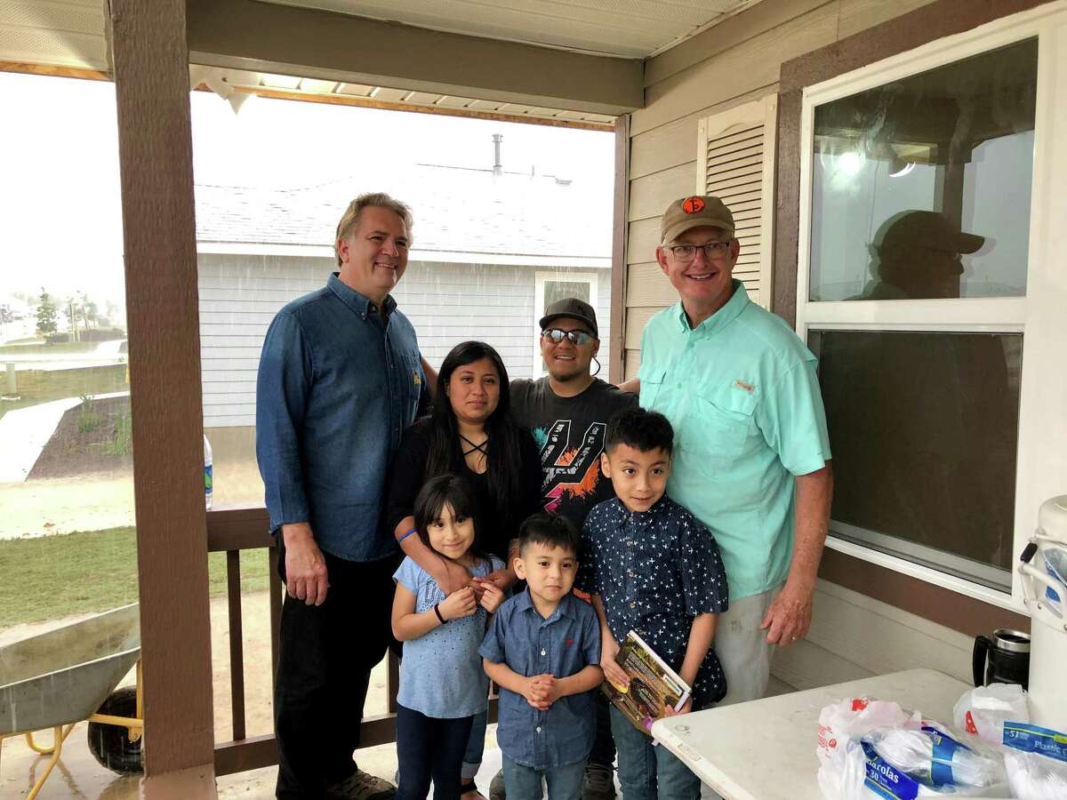 Troy Jessee, who owns Troy Jessee Construction, swam 3.5 miles of open water at Aransas Bay to raise more than $88,000 to build the Habitat for Humanity house for the Villarin family.Left to right front row Villarin children: Aubree, 6, Aram, 5, and Walter, 10.Left to right back row: Trinity Baptist Church senior pastor D. Leslie Hollon, Rosario Delgado, Aram Villarin and Troy Jessee.