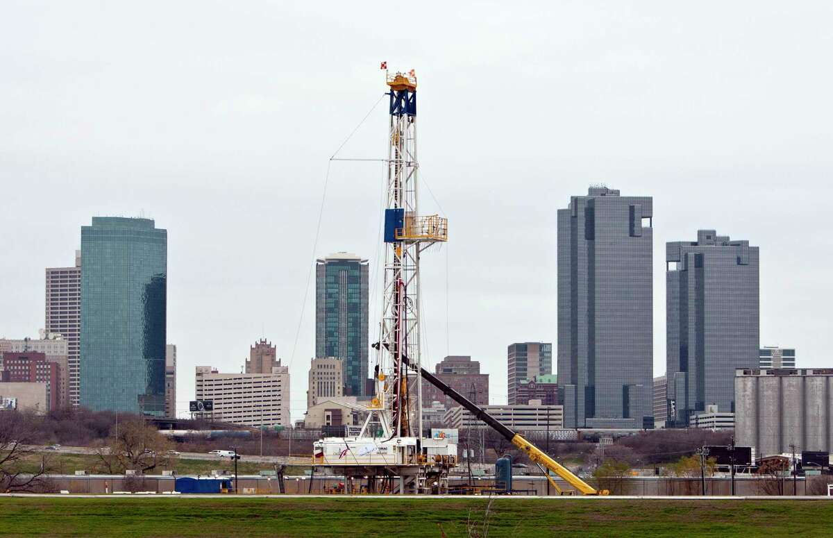A gas drilling rig operates on the banks of the Trinity River just east of downtown Fort Worth, Texas in December 2011. French oil major Total has filed plans to drill 16 new horizontal wells spread across 10 leases in the Barnett Shale of North Texas.