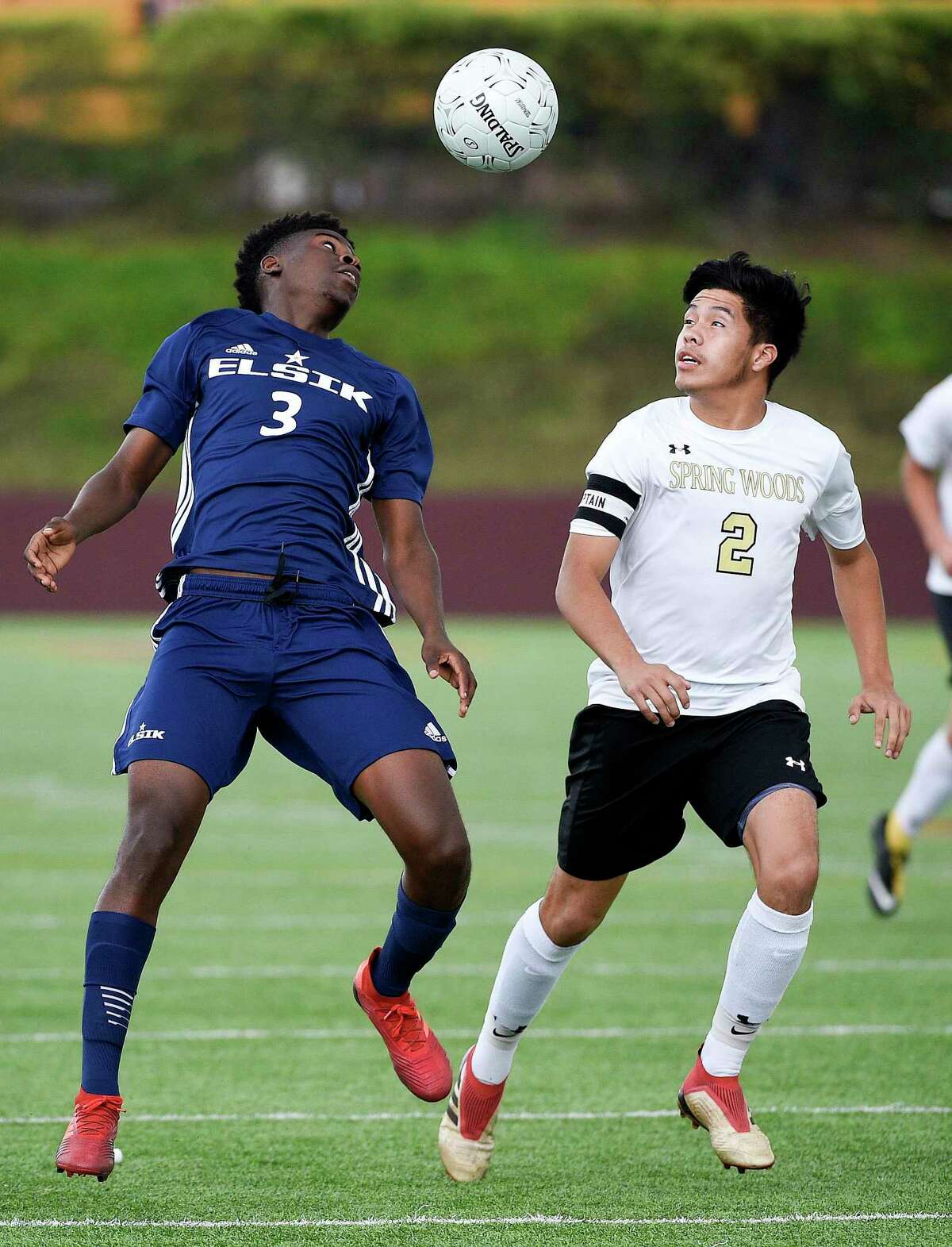 Elsik defender Samuel Nseng (3) heads the ball as Spring Woods defender Walter Constanza defends during the first half of a 6A region 3 final high school soccer match, Saturday, April 13, 2019, in Deer Park.