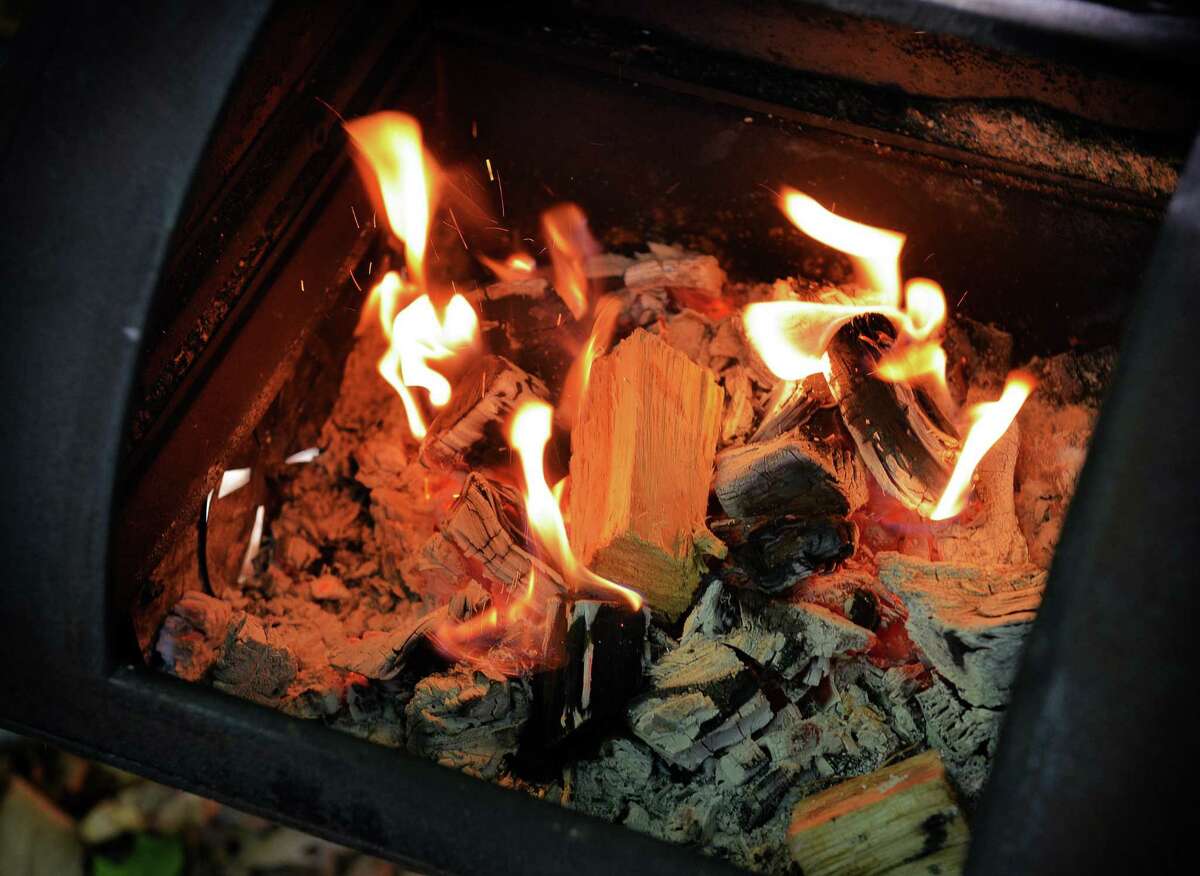 Chunks of fruitwood are added to the fire at a Texas-style barbecue party with smoked brisket, ribs and sausage. Low and slow is not the only way to barbecue.
